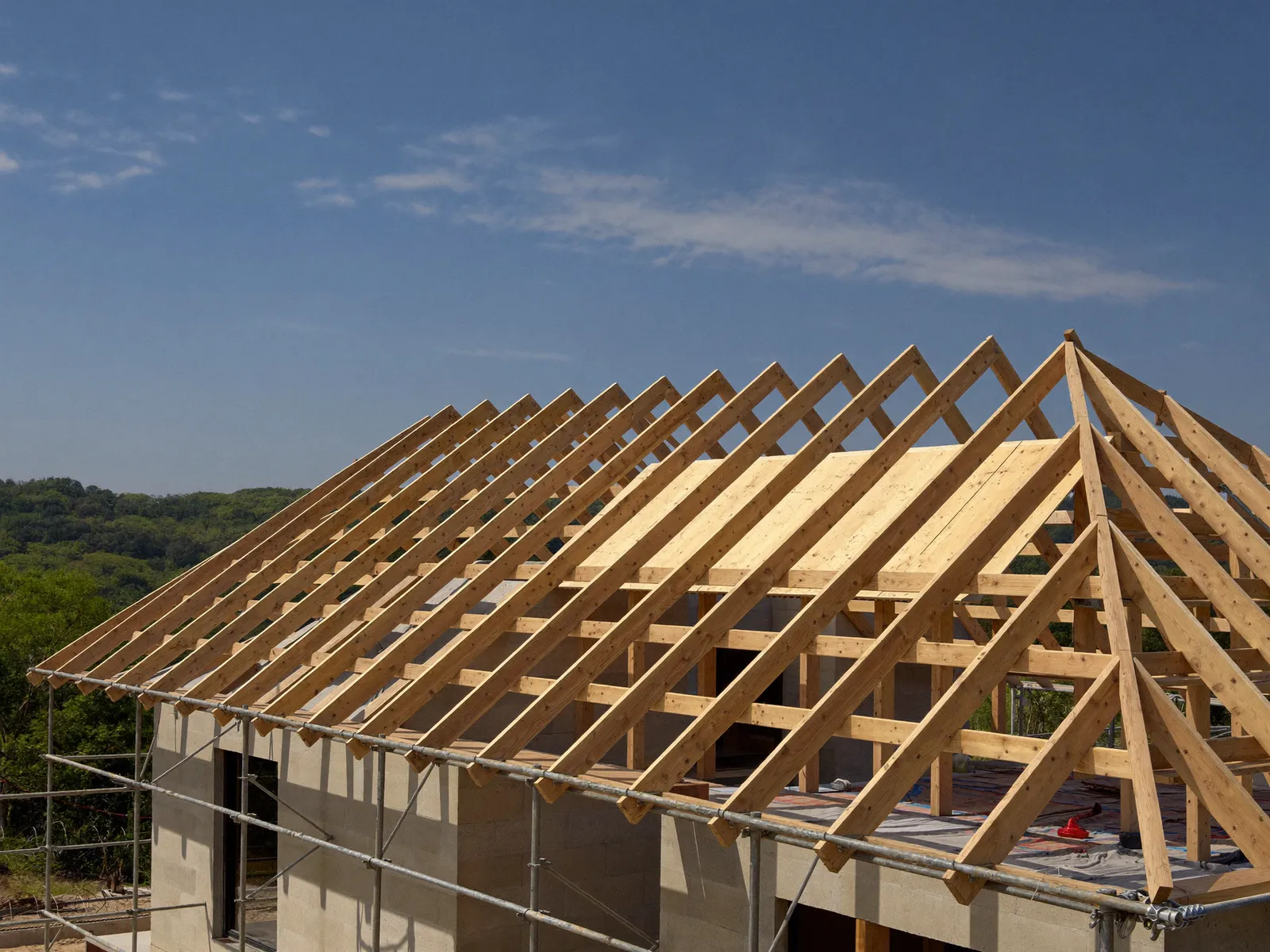 Roof truss framing over concrete-block walls with scaffolding
